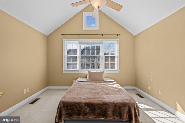 bedroom featuring lofted ceiling, carpet flooring, and visible vents