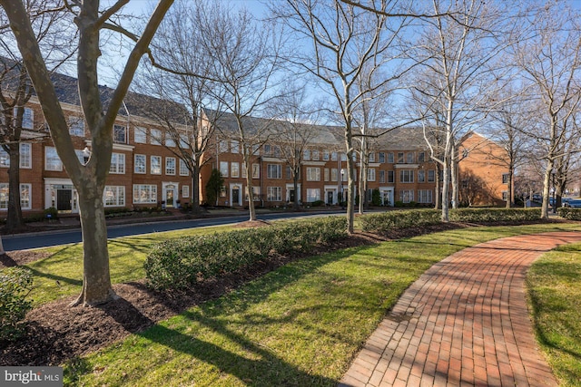 view of home's community featuring a residential view and a yard