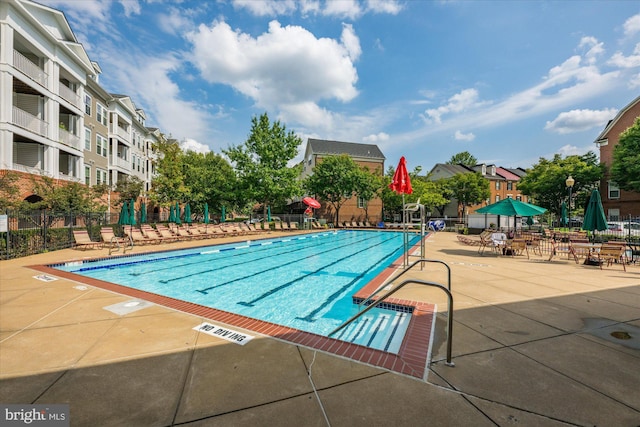 pool featuring a patio area and fence