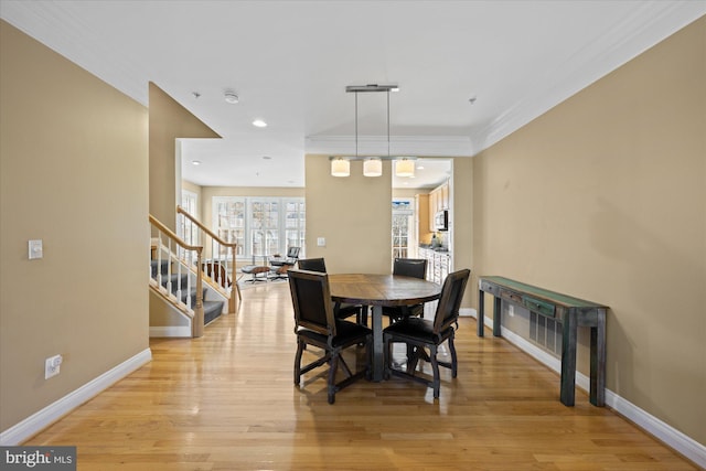 dining space with light wood finished floors, baseboards, stairs, ornamental molding, and recessed lighting