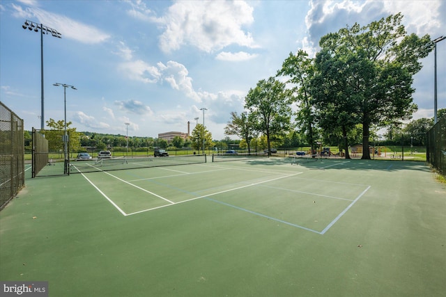 view of tennis court featuring fence