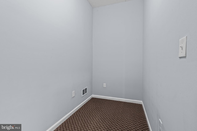 spare room with carpet, visible vents, and baseboards