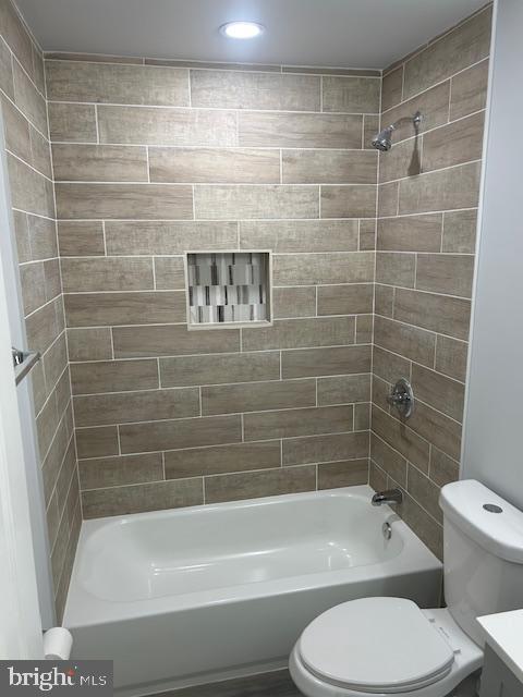 bathroom featuring shower / washtub combination, vanity, and toilet