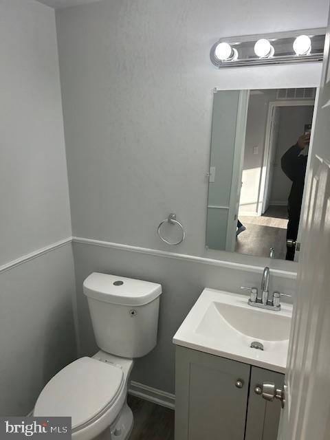 bathroom with vanity and toilet