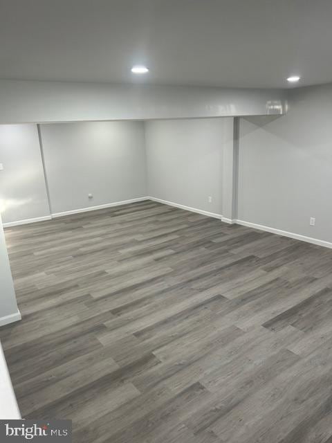 finished below grade area featuring recessed lighting, baseboards, and wood finished floors