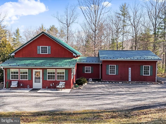 chalet / cabin with driveway and metal roof