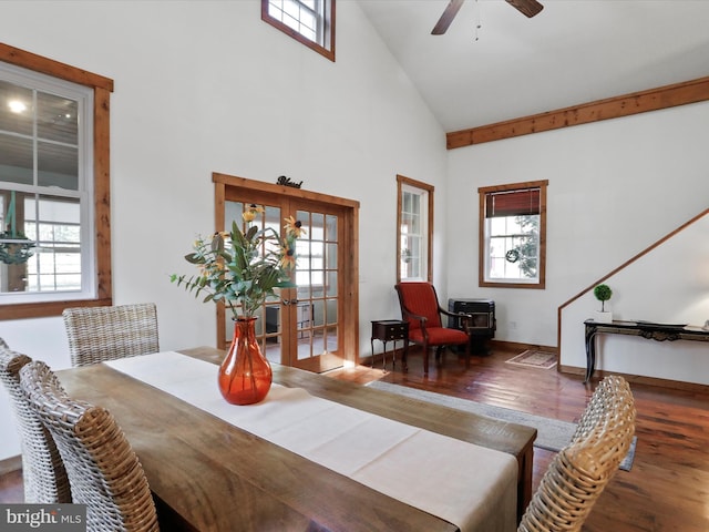 dining space with high vaulted ceiling, a healthy amount of sunlight, and hardwood / wood-style floors