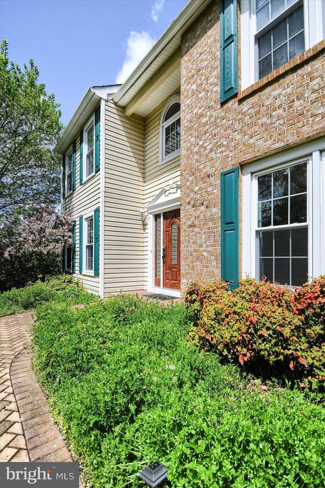 doorway to property with brick siding