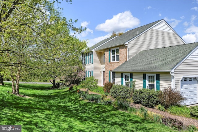 view of property exterior with a garage, a shingled roof, and a lawn