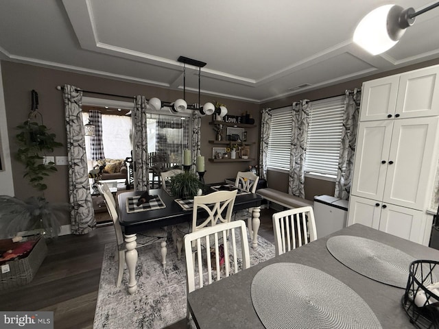 dining space with ornamental molding, a chandelier, and dark wood finished floors