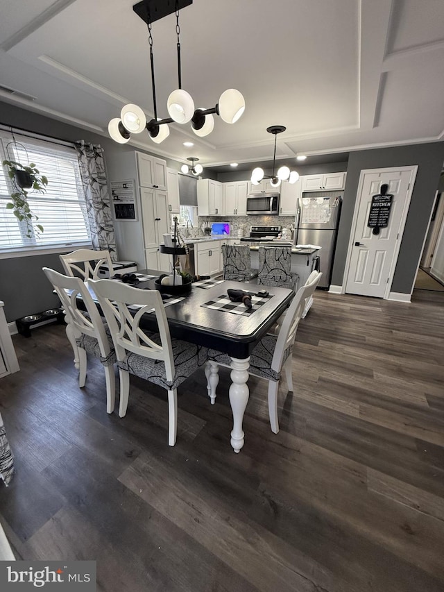 dining space featuring a tray ceiling, dark wood finished floors, and baseboards