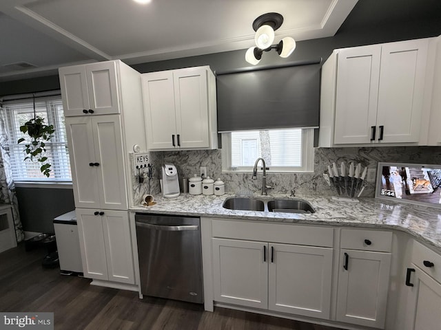 kitchen with tasteful backsplash, stainless steel dishwasher, dark wood-type flooring, white cabinets, and a sink