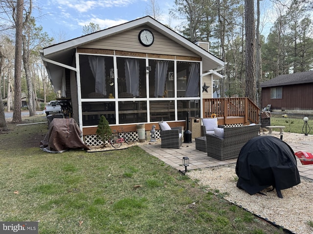 back of property featuring a sunroom, a patio area, and a yard