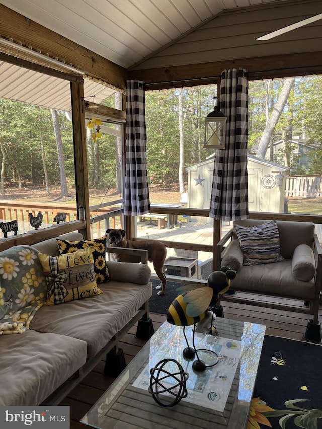 sunroom / solarium featuring vaulted ceiling