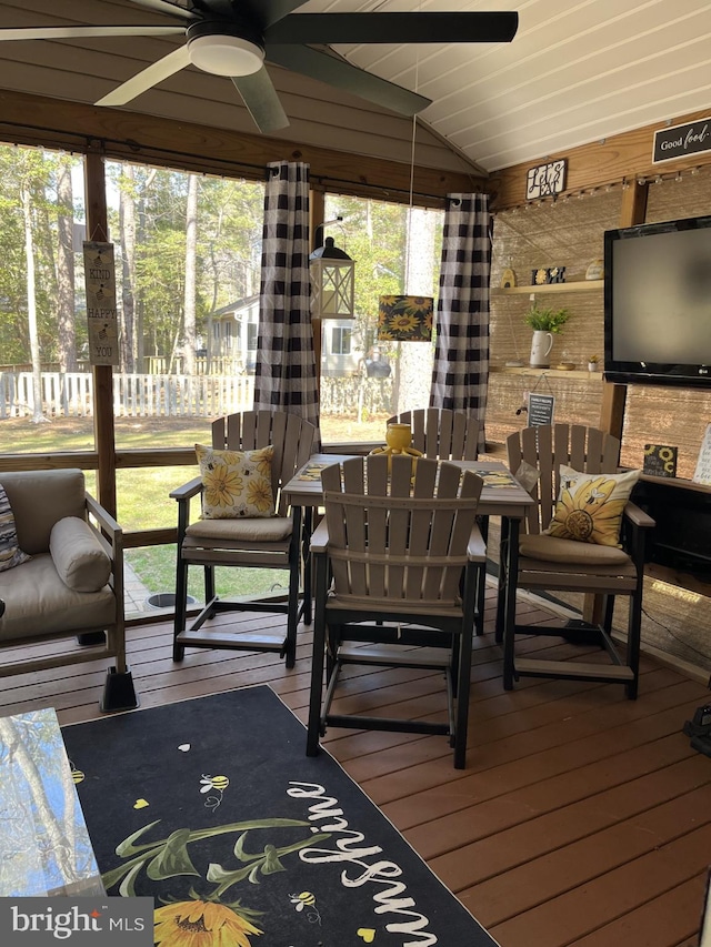 sunroom / solarium featuring lofted ceiling and ceiling fan