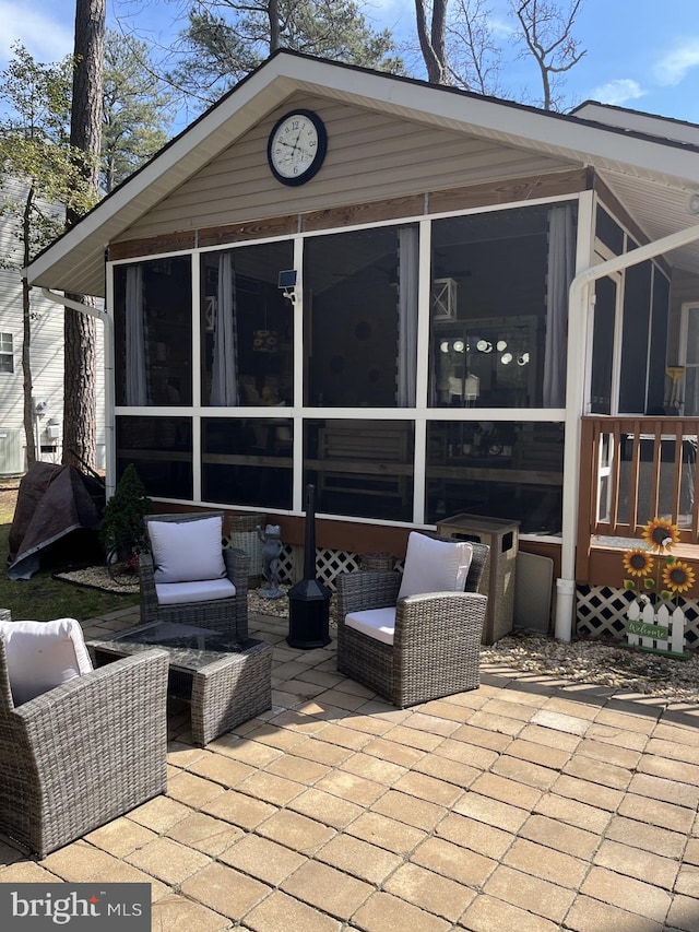 wooden terrace with a sunroom and a patio