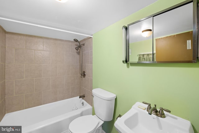 bathroom with toilet, a sink, and shower / bathtub combination