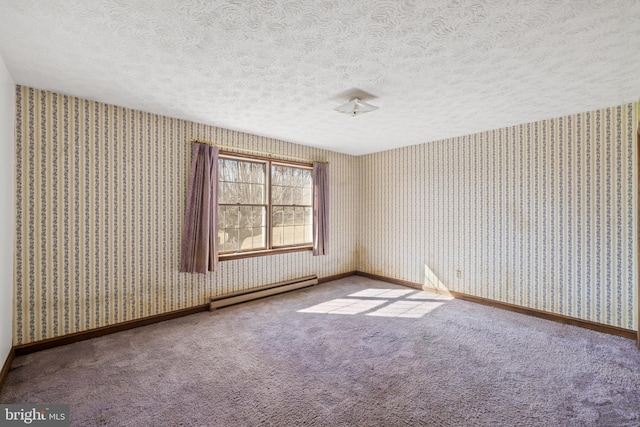 carpeted empty room featuring a baseboard heating unit, a textured ceiling, baseboards, and wallpapered walls