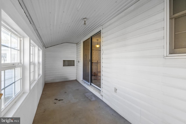 unfurnished sunroom featuring lofted ceiling and wood ceiling