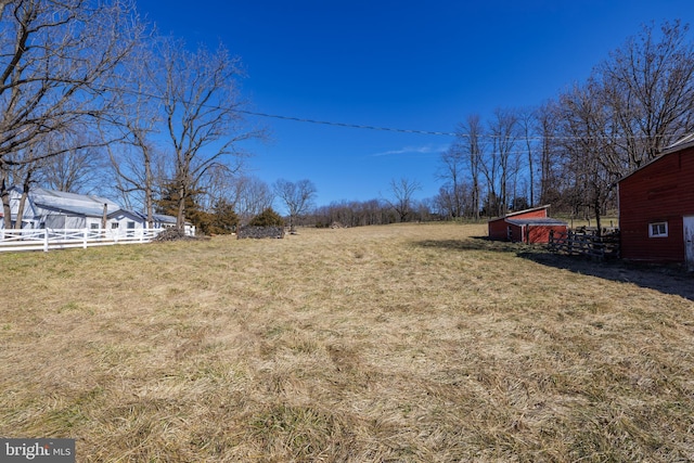 view of yard with an outdoor structure and fence