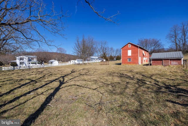 view of yard with an outdoor structure and fence