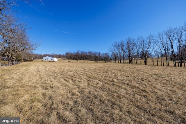 view of yard with a rural view