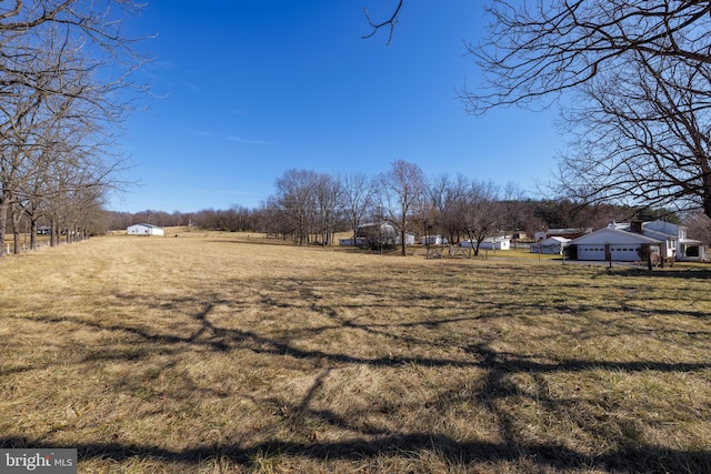 view of yard with a rural view