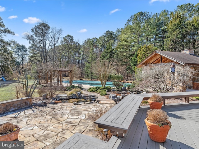 deck featuring a pool and a patio