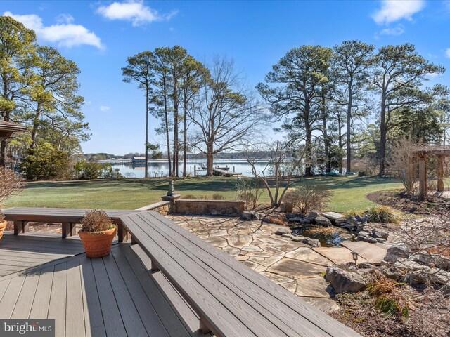 wooden deck featuring a yard and a water view