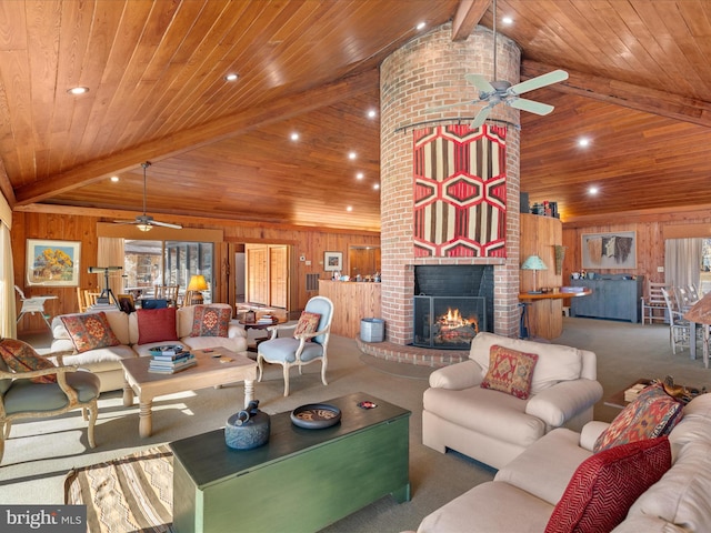 living room with wooden walls, a brick fireplace, vaulted ceiling with beams, carpet, and wood ceiling