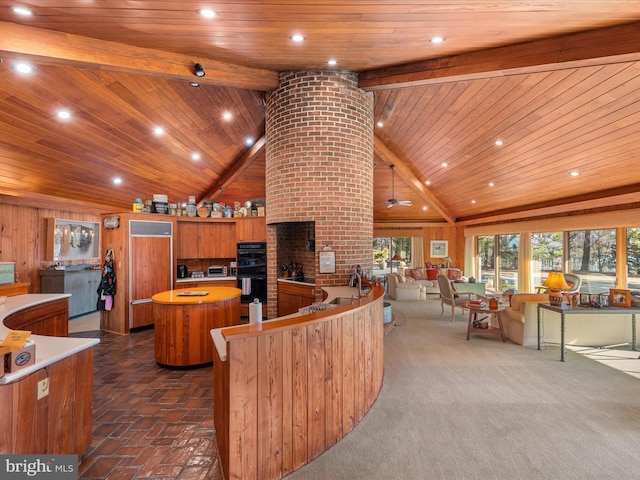 kitchen with a kitchen island, beam ceiling, brown cabinets, wooden ceiling, and dobule oven black