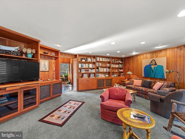 living room featuring recessed lighting, carpet floors, wooden walls, and built in features