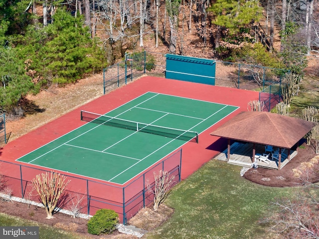 view of sport court featuring fence