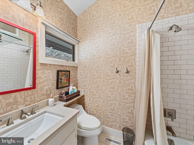 bathroom featuring wallpapered walls, toilet, vanity, and visible vents