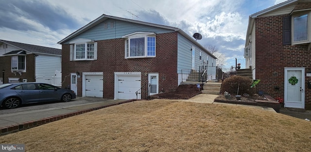 view of front of house featuring driveway, brick siding, a front lawn, and an attached garage