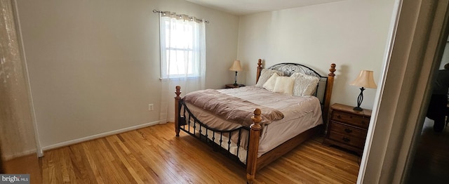 bedroom featuring light wood-type flooring and baseboards