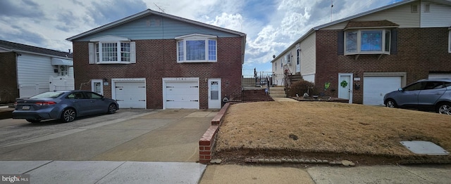 view of front of property with brick siding, driveway, and an attached garage