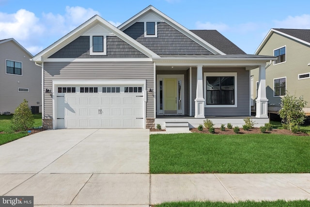 view of front of property with a garage, concrete driveway, and a front lawn