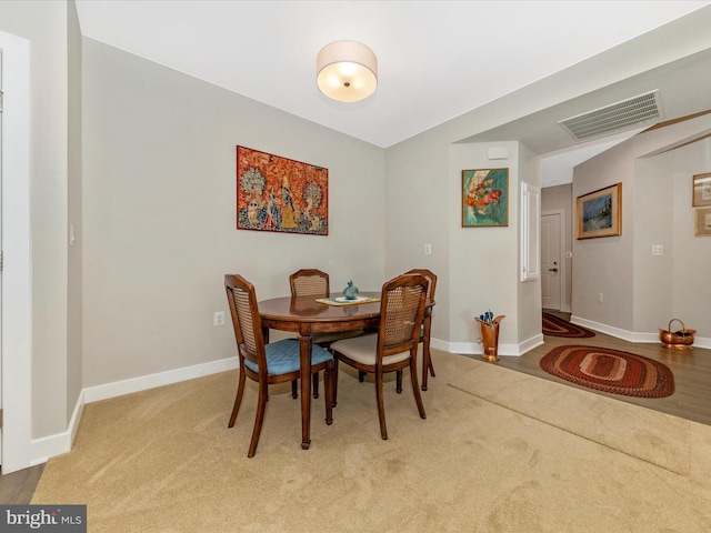 dining area featuring visible vents, baseboards, and carpet