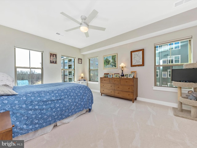 carpeted bedroom featuring a ceiling fan, baseboards, and visible vents