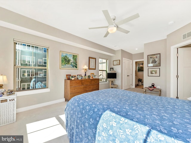 carpeted bedroom with a ceiling fan, baseboards, and visible vents