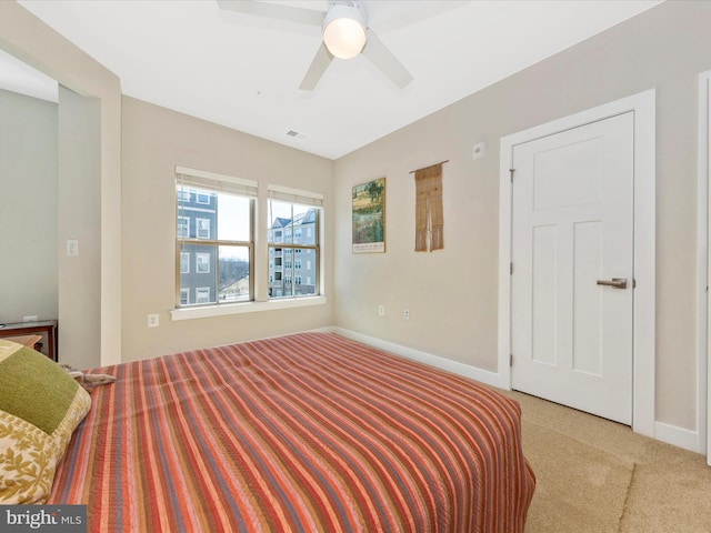 bedroom with light carpet, visible vents, ceiling fan, and baseboards