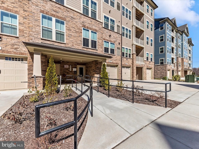 surrounding community featuring an attached garage and driveway