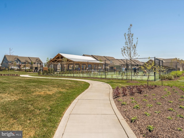 surrounding community with a residential view, a yard, and fence