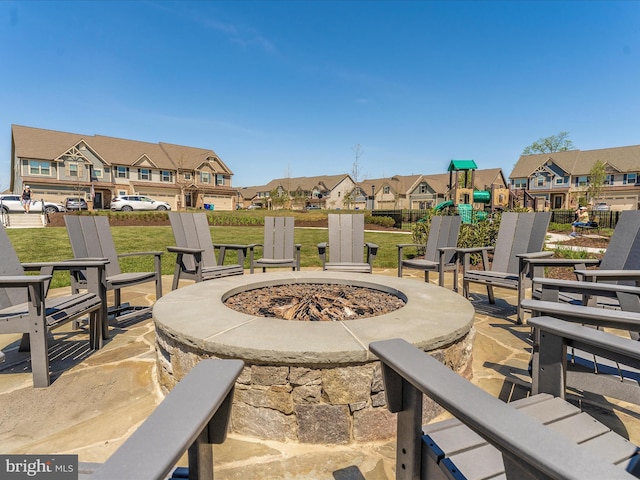 view of patio featuring a residential view, a fire pit, and playground community