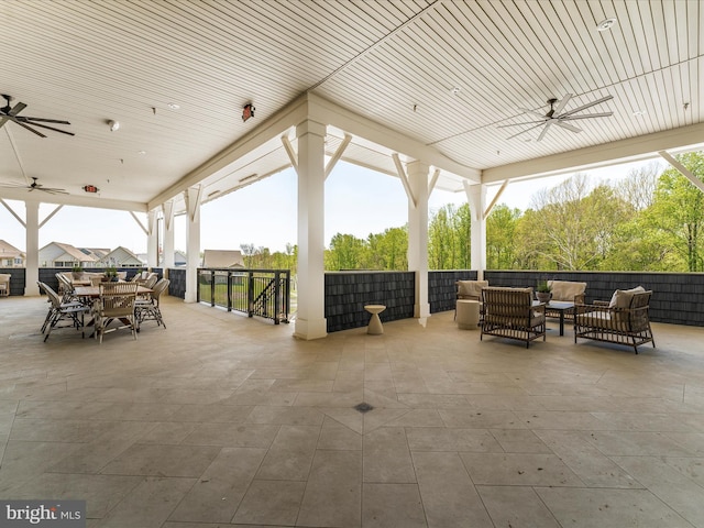 view of patio / terrace with an outdoor living space, outdoor dining space, and a ceiling fan