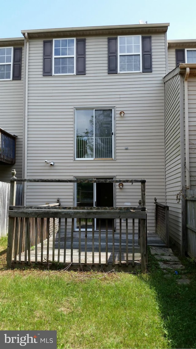 rear view of house featuring a wooden deck