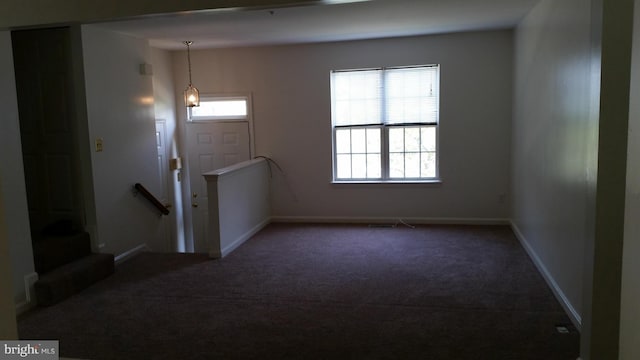 entrance foyer featuring a healthy amount of sunlight, carpet, and baseboards