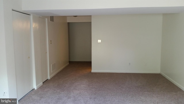 carpeted empty room with visible vents and baseboards