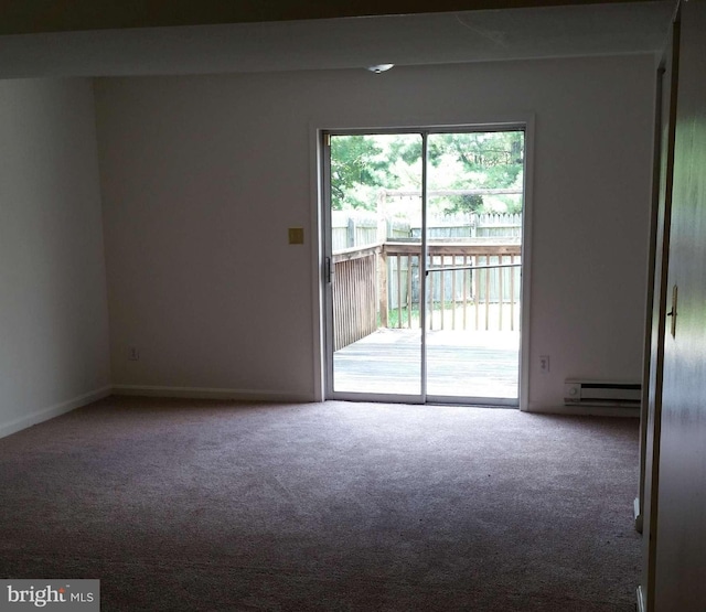 spare room with baseboard heating and carpet flooring